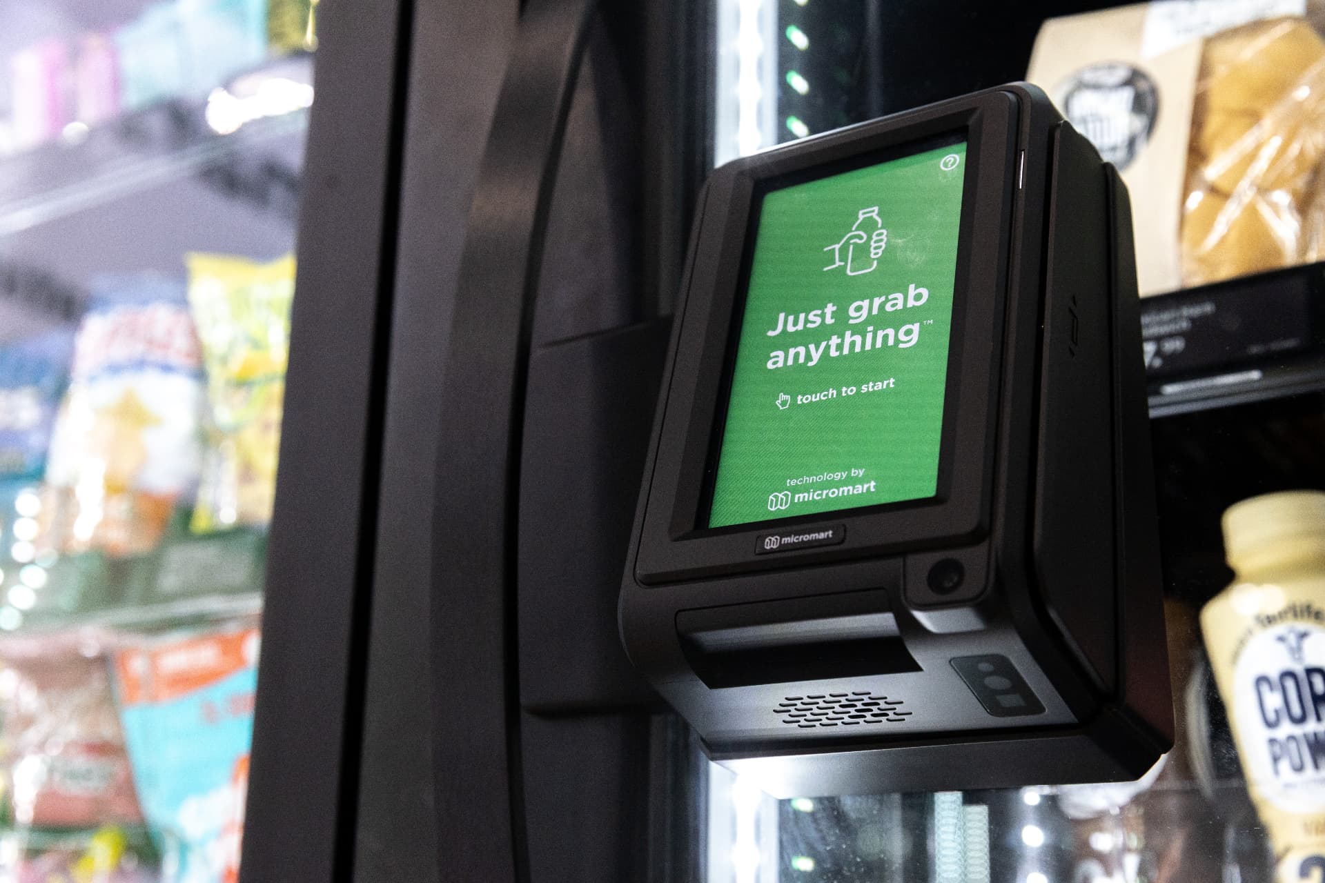 Micromart smart checkout screen showing Just grab anything touch to start